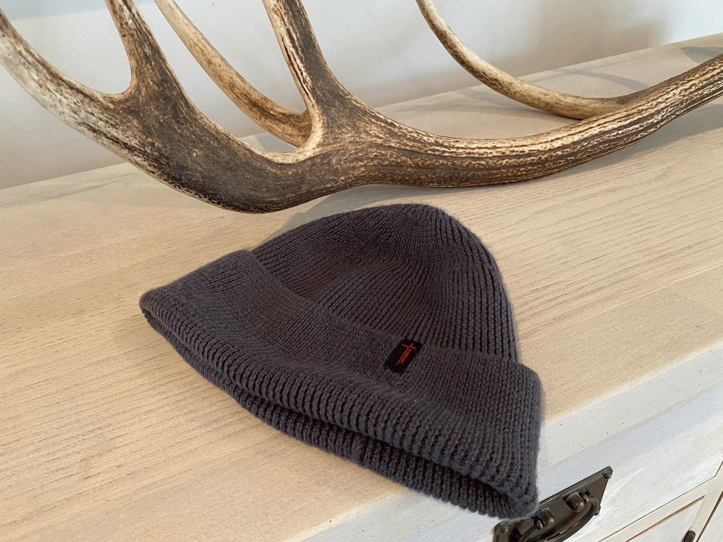 Grey beanie resting on cabinet